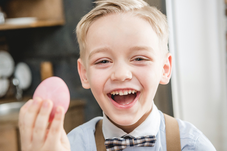 Boy holding Easter eggの写真素材