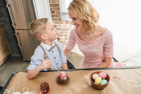 Mother and son painting Easter eggsの写真素材