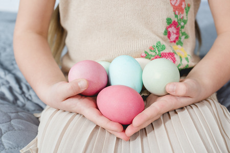 Girl holding Easter eggs