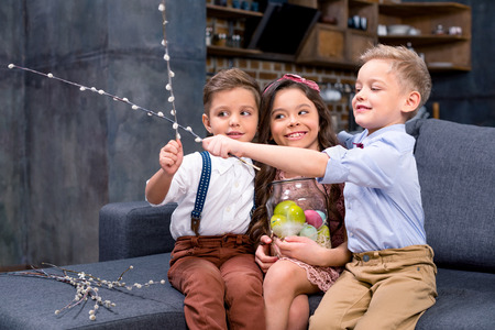 Kids with Easter eggs and catkinsの写真素材