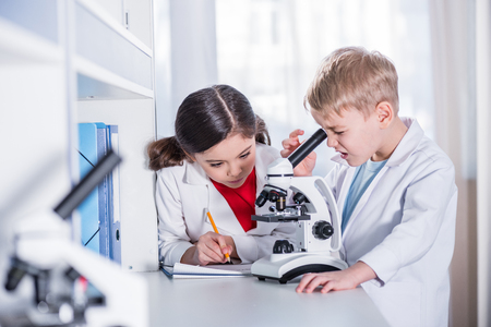Kids using microscopeの写真素材