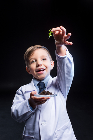 Little boy holding plantの写真素材