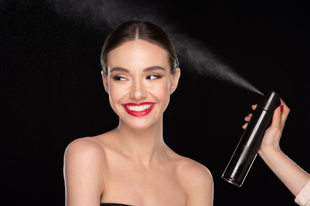 Pretty woman with hairsprayの写真素材