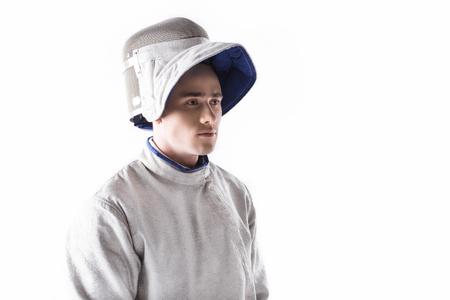portrait of serious fencer in mask and uniform for training