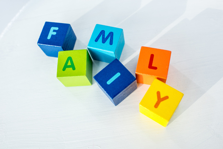 Colorful cubes with letters consists the word family on whiteの写真素材