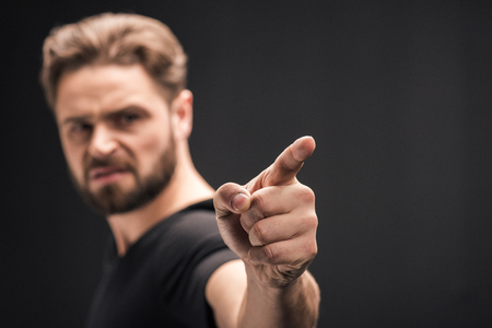 bearded man pointing on black with copy spaceの写真素材