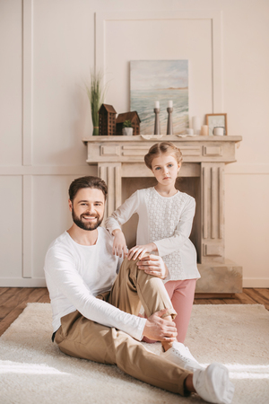 little girl with happy father looking at cameraの写真素材