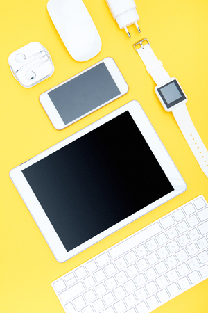 Flat lay of office supplies, keyboard, digital tablet, smartwatch and smartphoneの写真素材
