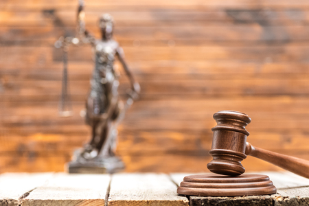 Close-up view of brown wooden mallet of judge on wooden table, law conceptの写真素材