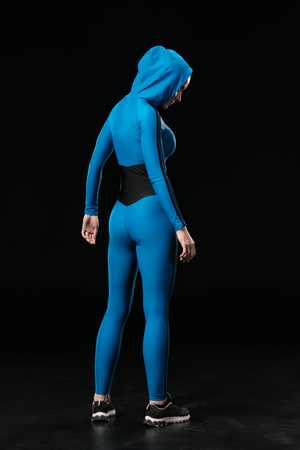 young fitness woman in sportswear standing isolated on blackの写真素材