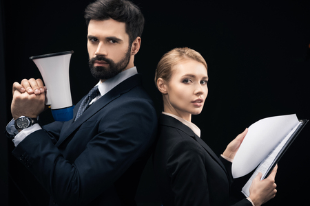 side view of confident business people with loudspeaker and papersの写真素材