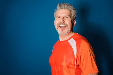 mature sportsman fitness manager smiling and looking at cameraの写真素材