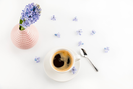 coffee mug and blue hyacinth flowers in vaseの写真素材