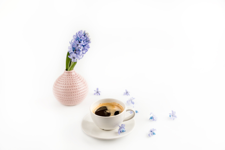 coffee mug and blue hyacinth flowers in vaseの写真素材