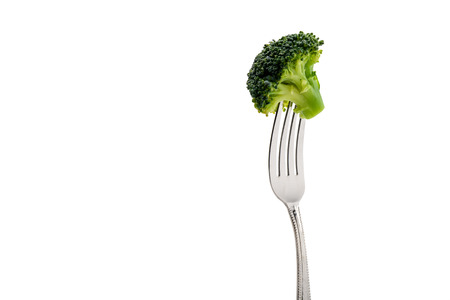 fresh broccoli on fork isolated on whiteの写真素材