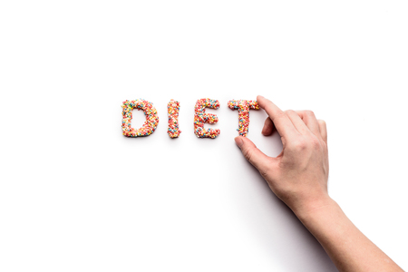 Top view of word diet made from sweets and human handの写真素材