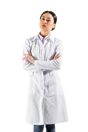 asian serious female doctor standing in white coatの写真素材