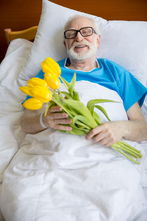 senior patient with tulip flowersの写真素材