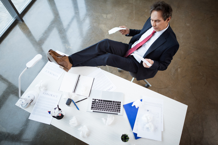 Mature businessman at workplaceの写真素材
