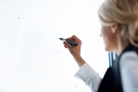 Businesswoman writing with penの写真素材