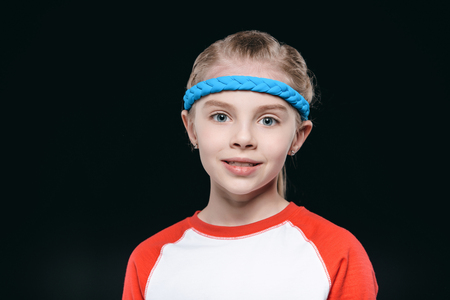 Portrait of cute blonde girl in sportswear looking at cameraの写真素材