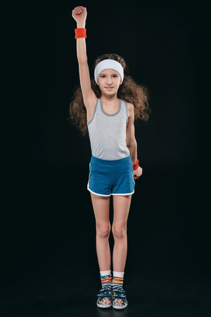 girl in sportswear exercising isolated on blackの写真素材