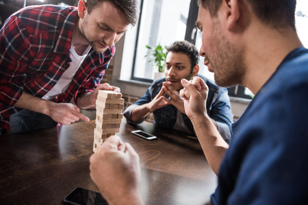 young people playing wooden block gameの写真素材