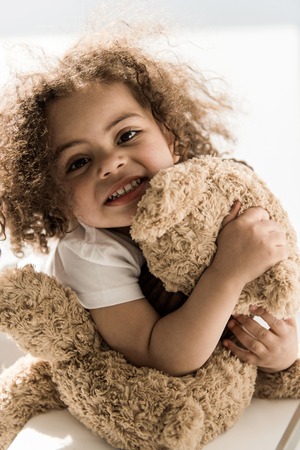baby girl with teddy bearの写真素材