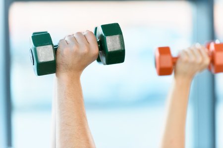 hands holding dumbbellsの写真素材