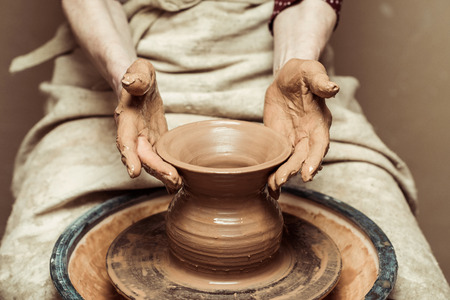 female hands working on potters wheelの写真素材