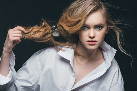 girl tying hair with watchの写真素材