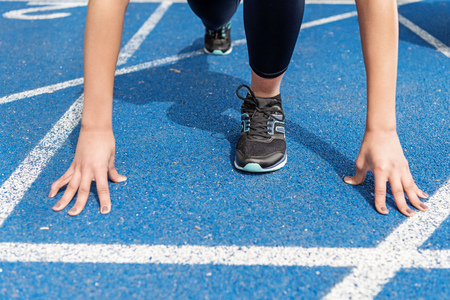 view of sportswoman on starting line at running track stadium