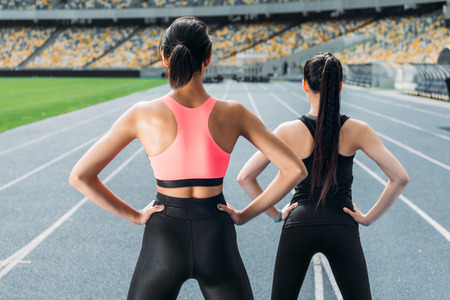 young women in sportswear exercising on running track stadiumの写真素材