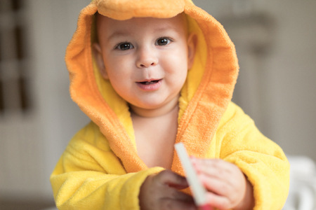 baby boy in yellow robeの写真素材