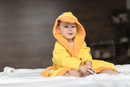 baby boy in yellow robeの写真素材