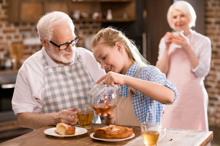 family drinking tea at homeの写真素材