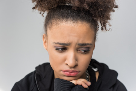 portrait of upset african american girl with curly hair isolatedの写真素材