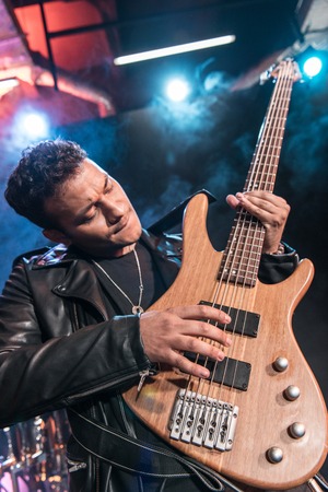 Electric guitar player playing hard rock music with bass guitarの写真素材