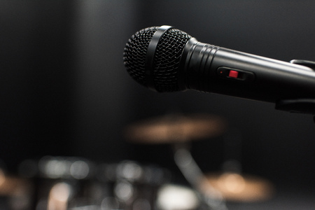 black electric microphone on empty stage