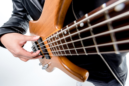 cropped view of rocker posing with electric guitar isolated on whiteの写真素材