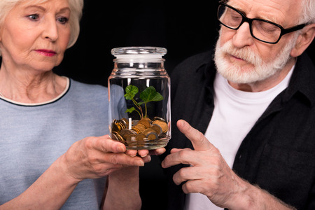 Couple with coins and plant in jar