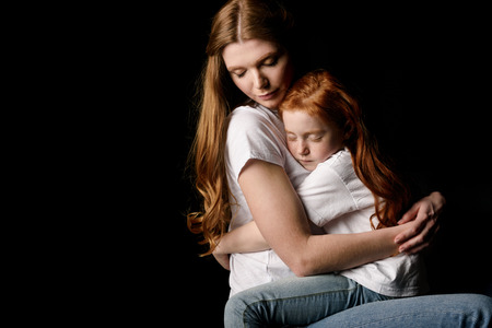 mother and little daughter hugging each otherの写真素材