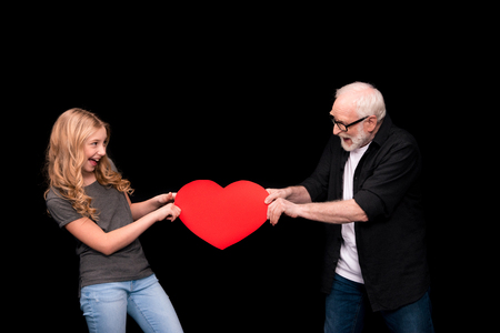 Grandfather and granddaughter with heart symbolの写真素材