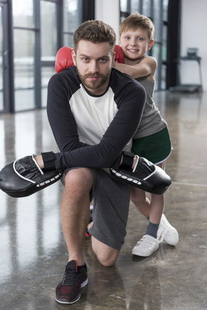 young boy boxer with his coach at trainingの写真素材