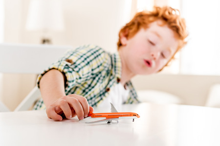 boy playing with toy at home, focus on foregroundの写真素材