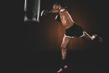 muay thai fighter training with punching bag, action sport conceptの写真素材