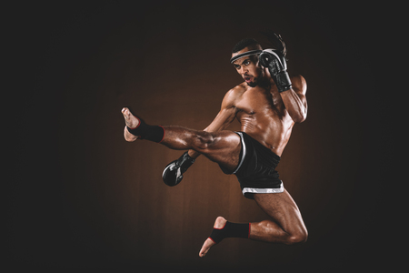 side view of angry trainign muay thai fighter in boxing glovesの写真素材