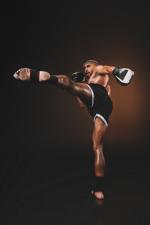 side view of muay thai fighter practicing kick,の写真素材