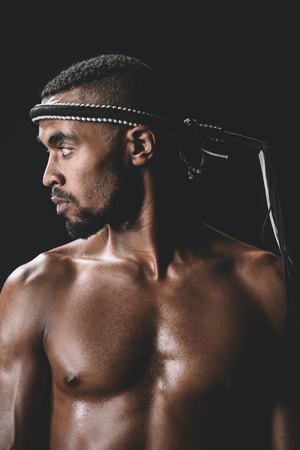 confident muay thai fighter with mongkhon on head isolated on blackの写真素材