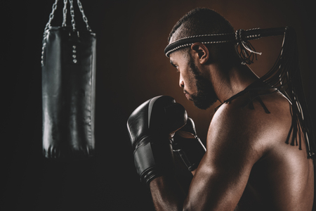 focused muay thai fighter in boxing glovesの写真素材